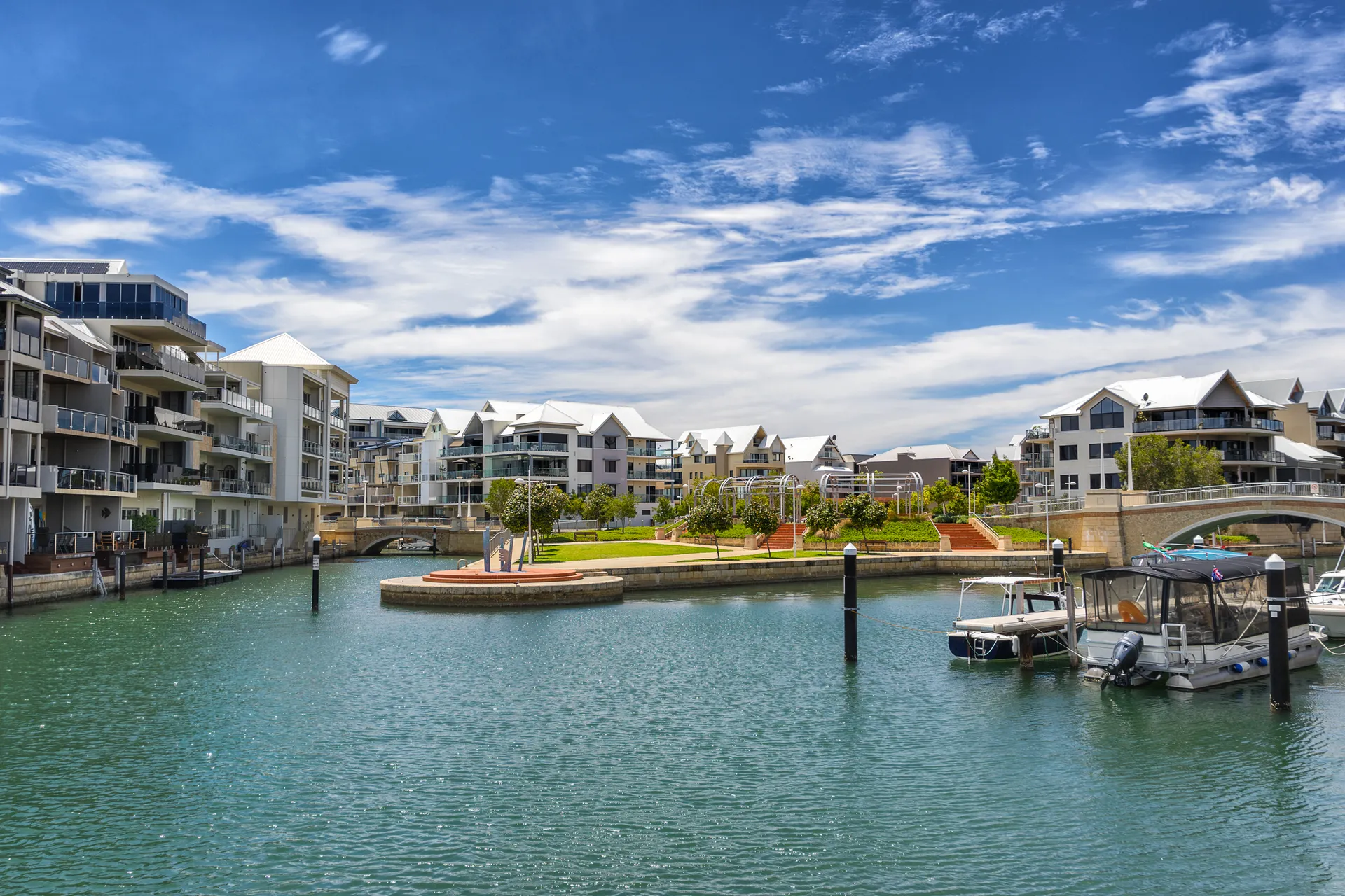 Boats moored on the calm canals of Mandurah at sunset